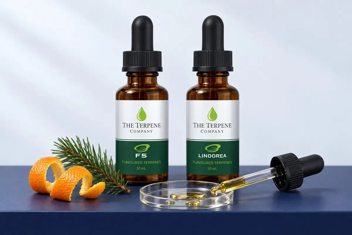 Hemp-derived terpenes from The Terpene Company: F5 and Lindorea in 50 mL amber dropper bottles, with a dish of terpene drops, orange peel and pine