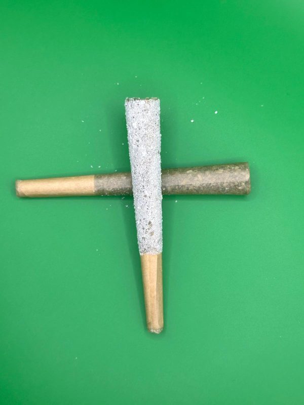 Iced THCA pre-roll coated in crystals crossed over a regular THCA pre-roll